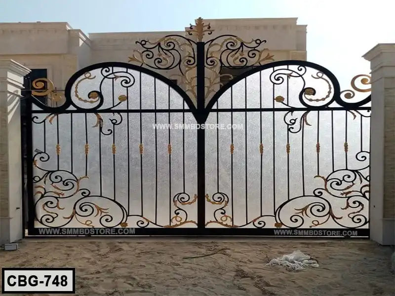 Decorative wrought iron boundary gate with ornate gold accents installed at a modern home exterior. Main image
