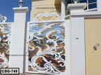 Decorative white and gold cast iron boundary gate with ornate floral pattern design.