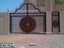 Decorative wrought iron boundary gate with intricate floral and geometric patterns for home exterior