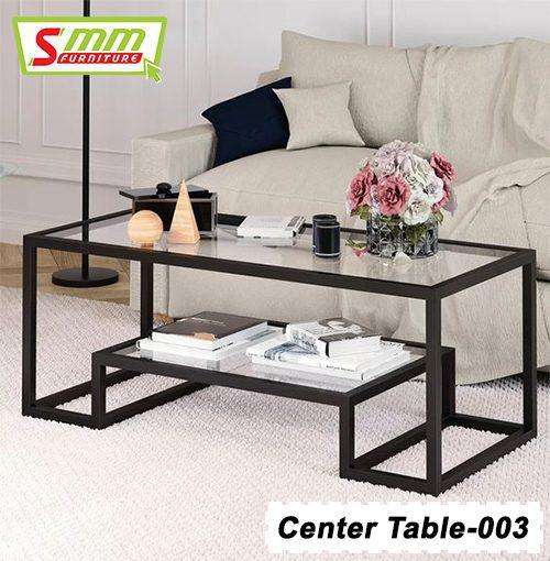 Modern glass top center table with black metal frame in a living room setting Main image