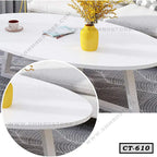 Modern white center table with metal legs, yellow vase, and cup in a living room