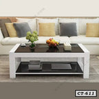 Modern black and white center table in a living room with sofa and decorative accents