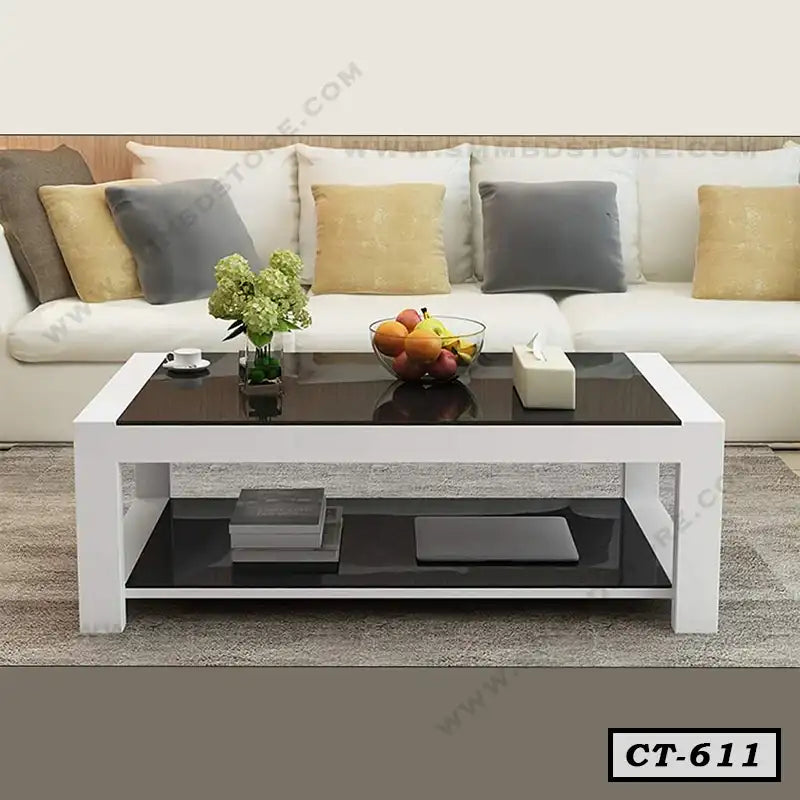 Modern black and white center table in a living room with sofa and decorative accents