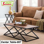 Modern center table with geometric black metal base and wooden top in a cozy living room