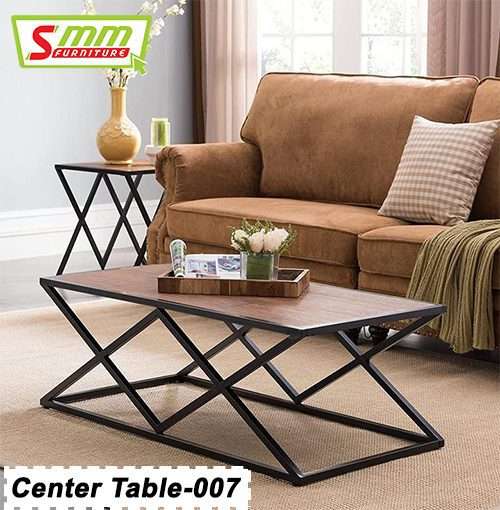 Modern center table with geometric black metal base and wooden top in a cozy living room