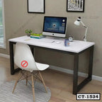 Modern computer table with white top, black metal legs, and office essentials in a home workspace.