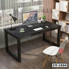 Modern black computer table with metal legs in home office, desktop monitor, chair and lamp