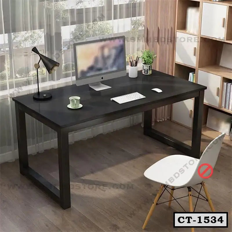 Modern black computer table with metal legs in home office, desktop monitor, chair and lamp