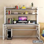 Modern computer table with shelves, desktop PC, books, plants, and decorative items