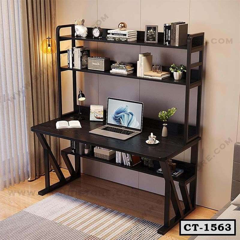 Modern black computer table with storage shelves, laptop, books, and plants in a home office