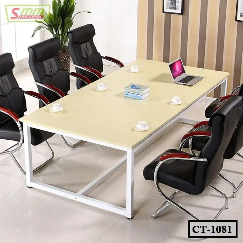 Modern conference table with six black office chairs, laptop, books, and coffee cups in meeting room. Main image