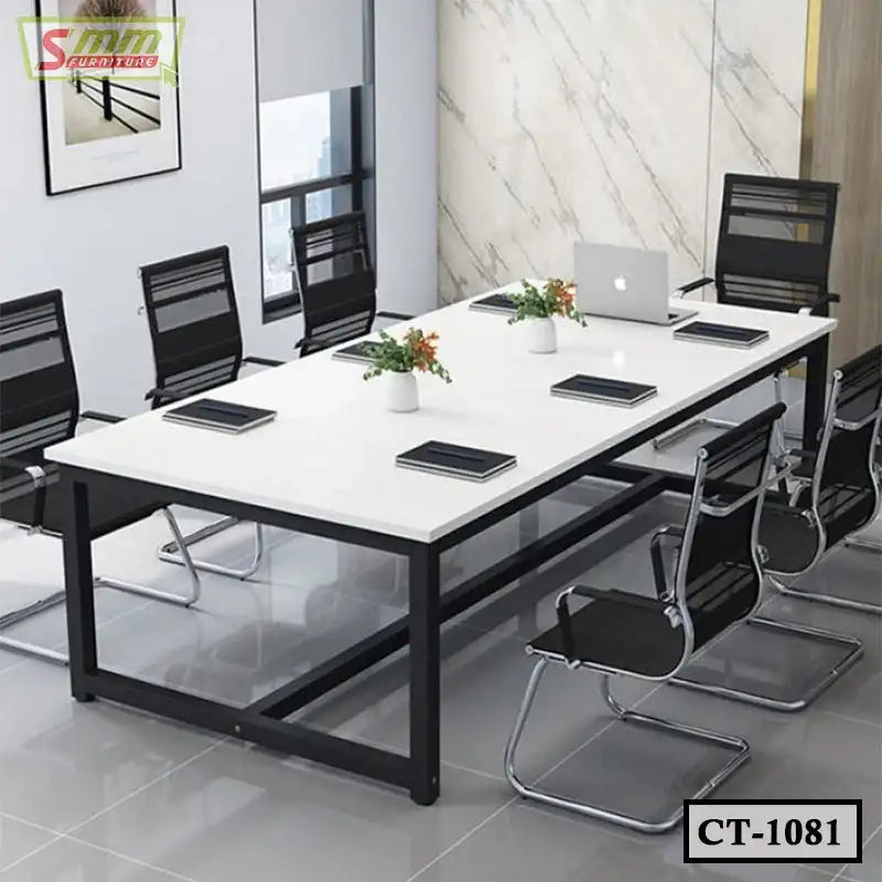 Modern conference table with white tabletop, black frame, and eight black office chairs in a meeting room.