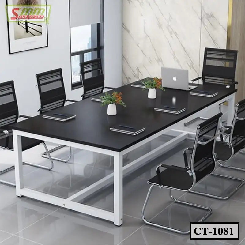 Modern black conference table with metal frame and office chairs in a meeting room