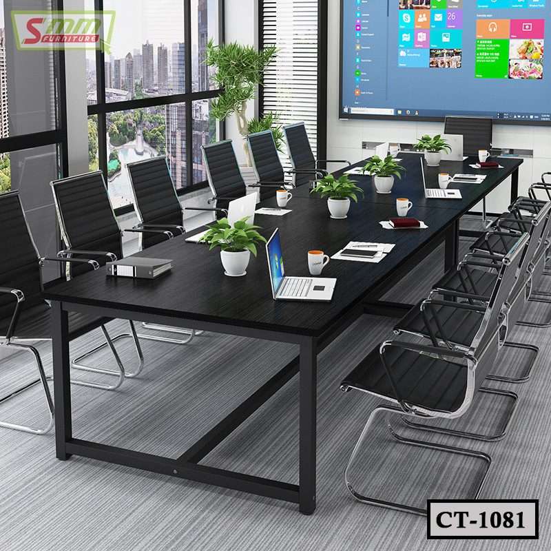 Modern black conference table with office chairs, laptops, potted plants, and city view windows
