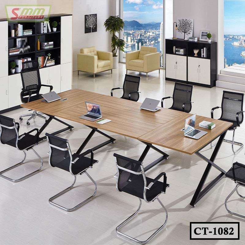 Modern conference table with mesh chairs in a bright office with city view