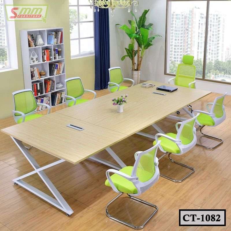 Modern conference room with large wooden meeting table, green mesh chairs and city view window Main image