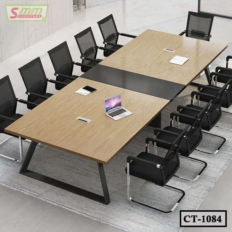 Modern conference table with metal legs and black mesh chairs in a boardroom setting Main image