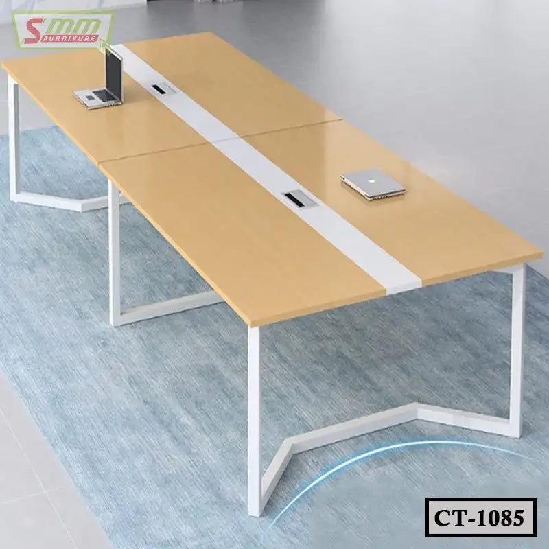 Modern rectangular wooden conference table with white metal legs, laptops on top