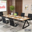 Modern conference table with black chairs in office meeting room setting