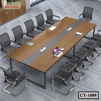 Modern conference room with a large rectangular wooden meeting table and mesh chairs