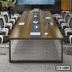Modern conference table with wooden top, surrounded by black office chairs in meeting room