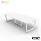 Modern white rectangular conference table with metal legs in a minimal office setting