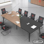 Modern conference table with wood and black finish, surrounded by mesh office chairs
