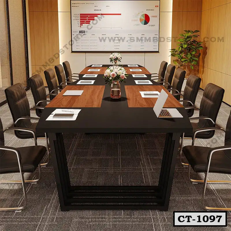 Modern conference table with black and wood finish, surrounded by office chairs in meeting room
