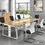 Modern conference table with black and white chairs in a bright office meeting room