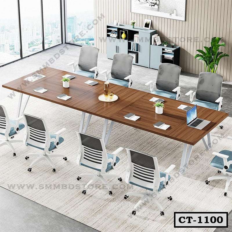 Modern rectangular wooden conference table with office chairs in a bright meeting room