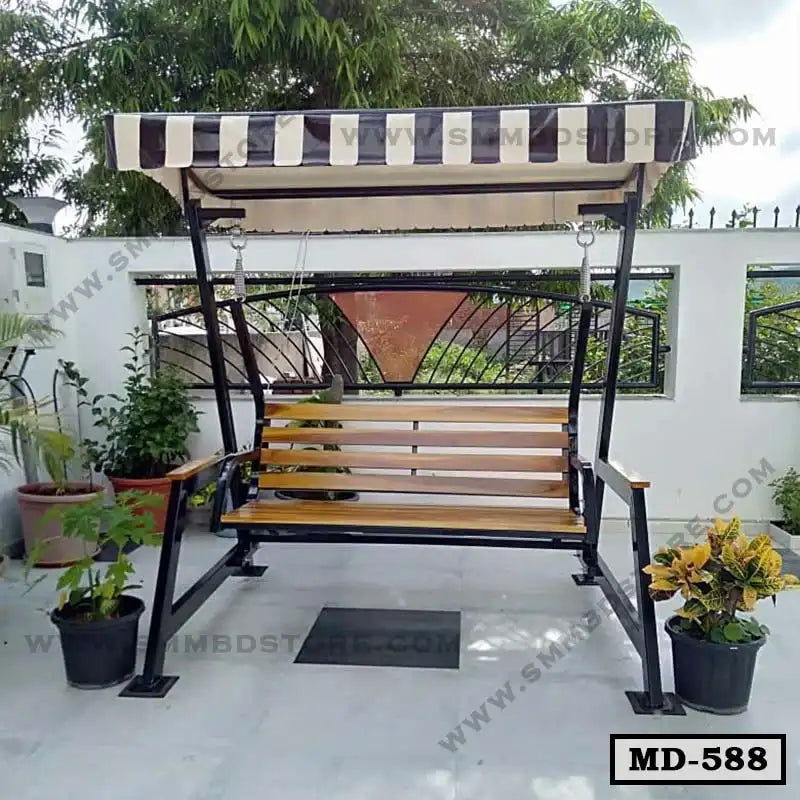 Outdoor metal and wood patio swing with canopy, surrounded by potted plants on a rooftop