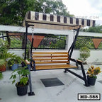 Outdoor wooden swing chair with metal frame and striped canopy on terrace with potted plants