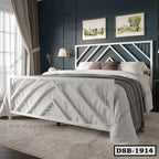 Modern white steel double bed with geometric design, cozy bedding, in a stylish bedroom