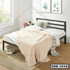 Modern double steel bed with minimalist black frame and cozy bedding in bright bedroom