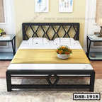 Modern double steel bed with geometric frame, pillows, and bedside tables in a bedroom
