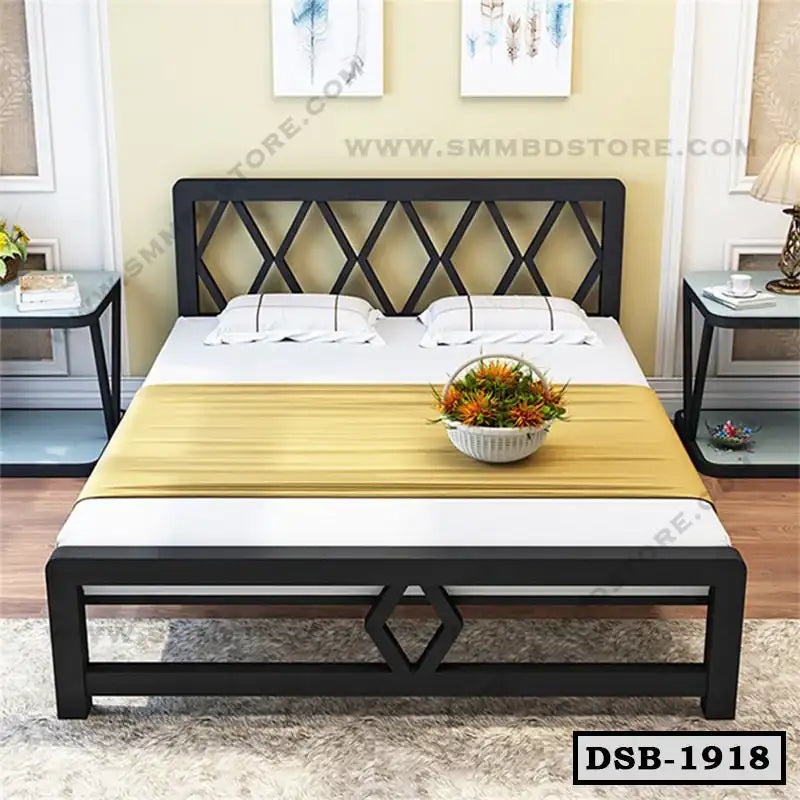 Modern double steel bed with geometric frame, pillows, and bedside tables in a bedroom