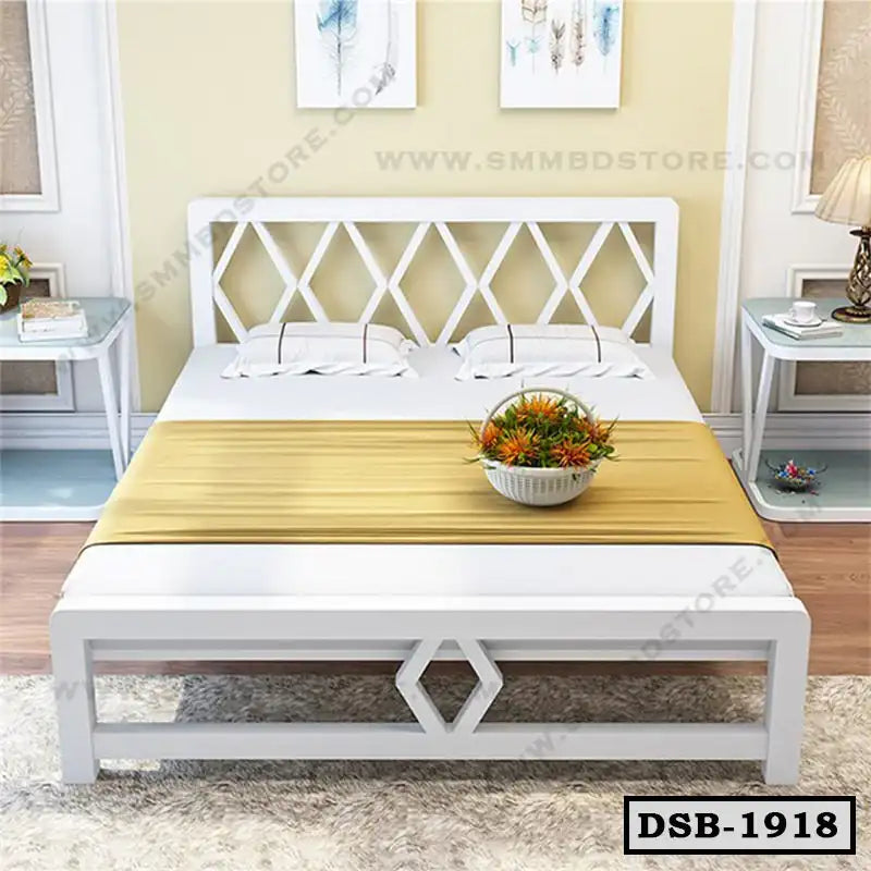 Modern double steel bed with white geometric frame, two pillows, and gold bed runner in bedroom