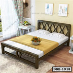 Modern double steel bed with lattice headboard, white bedding, and decorative yellow throw in a cozy bedroom.