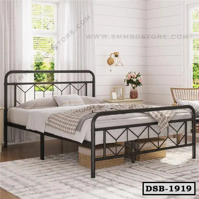 Modern double steel bed frame in a bright bedroom with light decor and large windows