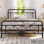 Modern double steel bed with geometric frame in a bright bedroom, decorative pillows, and baskets underneath.