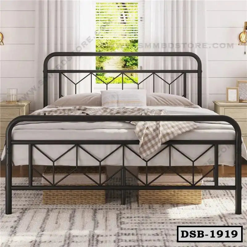 Modern double steel bed with geometric frame in a bright bedroom, decorative pillows, and baskets underneath.