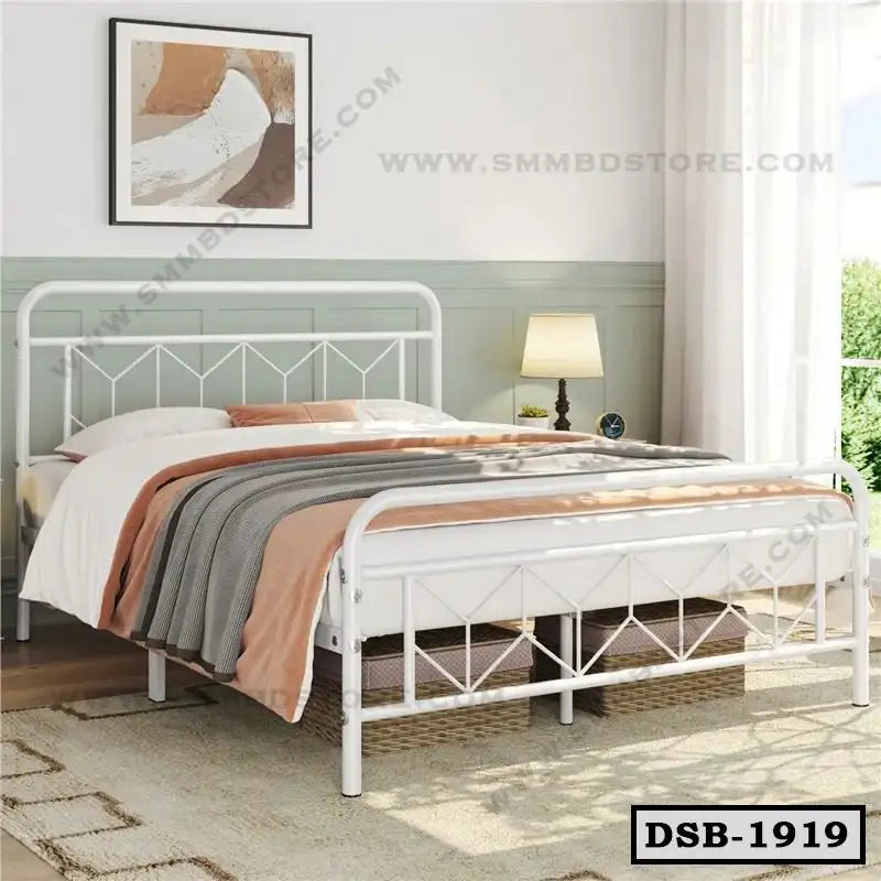 Modern white steel double bed with geometric frame, cozy bedding, and minimalist bedroom decor.