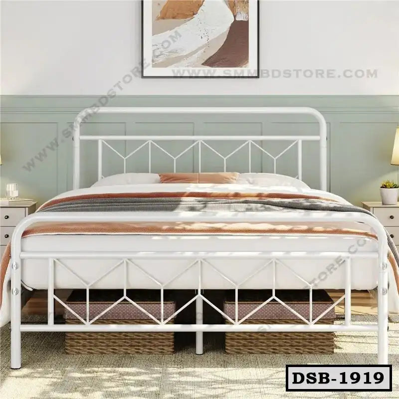 White double steel bed with geometric headboard, modern bedroom decor, storage baskets underneath