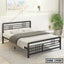 Modern double steel bed with black frame in a bright, minimalist bedroom setting.