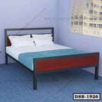Modern double steel bed with wood panel headboard in a bright bedroom with blue decor