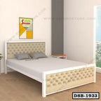 Modern double steel bed with tufted headboard in a bright bedroom, side table, large window