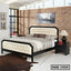 Modern double steel bed with cream tufted headboard in a stylish bedroom setting