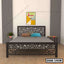 Modern double steel bed with decorative geometric headboard in a minimal bedroom