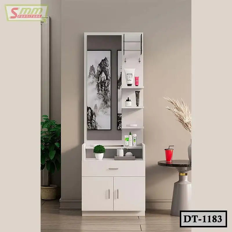 Modern white dressing table with mirror, shelves, decor items, and beauty products against beige wall