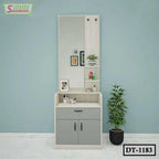 Modern wooden dressing table with large mirror, gray storage cabinets, and shelves, next to a potted plant.